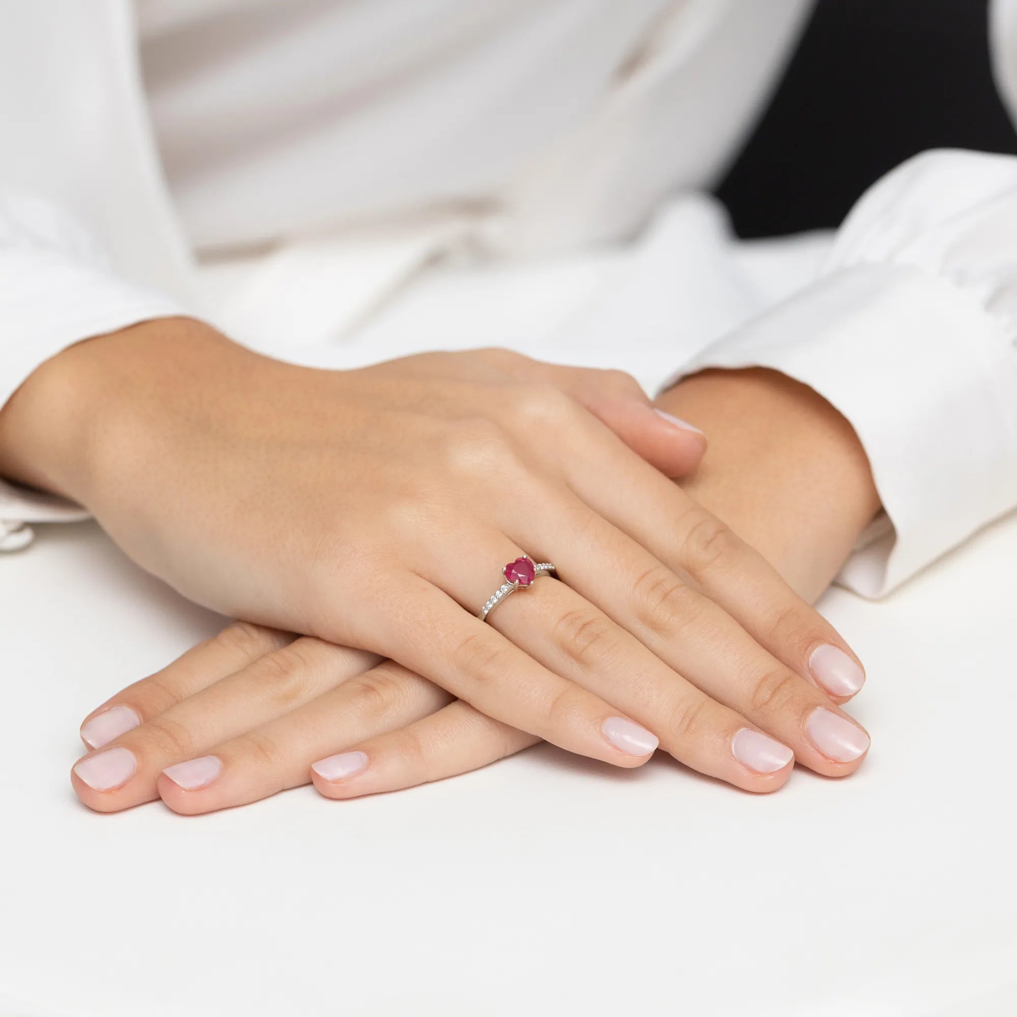 14k white gold ring with rubin heart and 0.10ct diamonds. Packed in black box, paper, and gift bag.